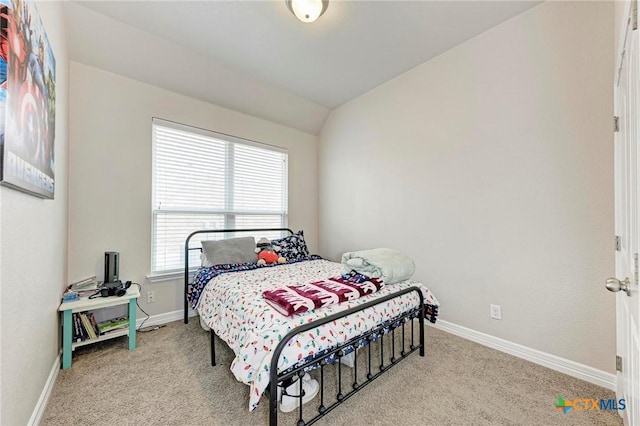 carpeted bedroom with vaulted ceiling