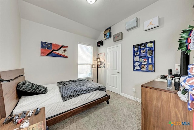 bedroom featuring carpet flooring and lofted ceiling