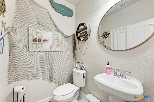 bathroom featuring toilet and sink