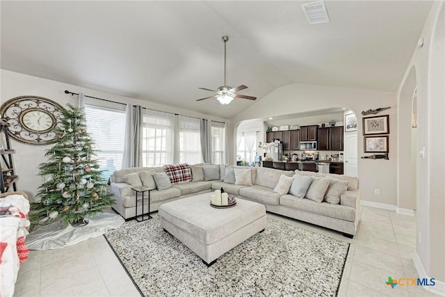 living room featuring light tile patterned floors, ceiling fan, and lofted ceiling