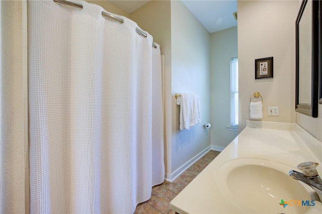 full bath with tile patterned floors, vanity, and baseboards