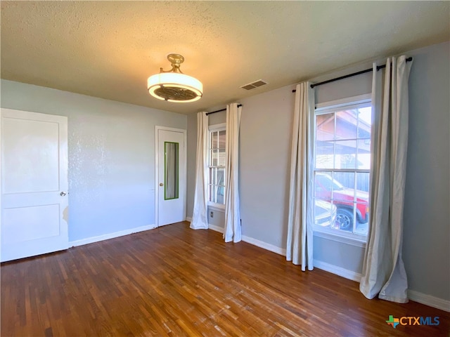 unfurnished bedroom with dark hardwood / wood-style floors