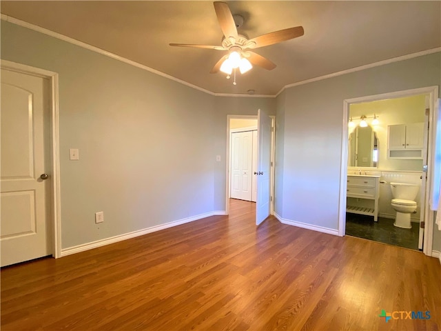 unfurnished bedroom with ensuite bathroom, ceiling fan, hardwood / wood-style flooring, and ornamental molding