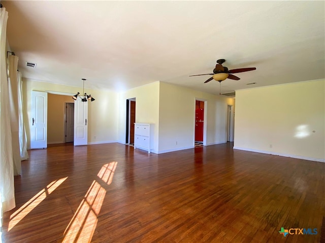 spare room with ceiling fan with notable chandelier and dark hardwood / wood-style floors