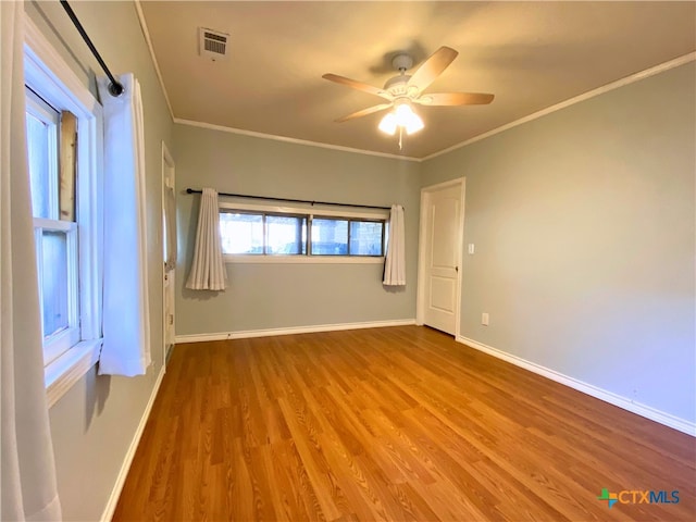 spare room featuring ceiling fan, light hardwood / wood-style floors, and crown molding