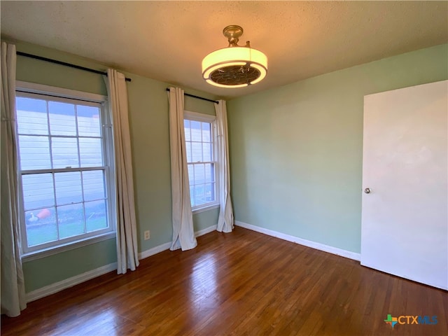 unfurnished room with dark hardwood / wood-style floors