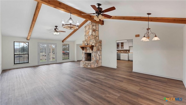 unfurnished living room featuring ceiling fan with notable chandelier, a stone fireplace, and dark wood-type flooring