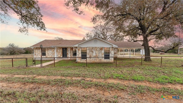 ranch-style home featuring a yard