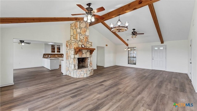 unfurnished living room with a fireplace, beam ceiling, dark hardwood / wood-style floors, and high vaulted ceiling