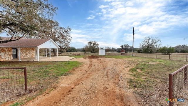 view of yard with a rural view