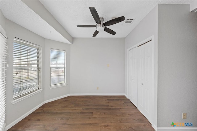 1311 Speight Ave, Waco, TX 76706 - unfurnished bedroom featuring ceiling fan, dark wood-type flooring, a closet, and a textured ceiling