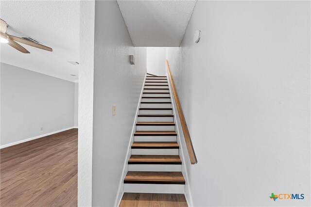 1311 Speight Ave, Waco, TX 76706 - stairs with ceiling fan, hardwood / wood-style floors, and a textured ceiling