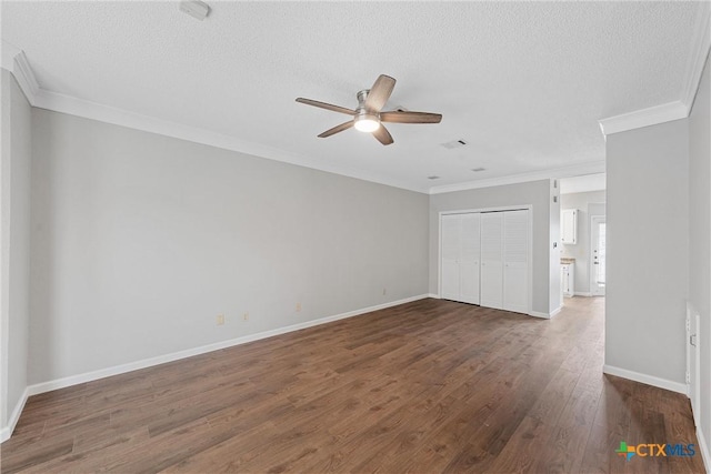 1311 Speight Ave, Waco, TX 76706 - unfurnished bedroom featuring dark hardwood / wood-style flooring, ornamental molding, a closet, and a textured ceiling