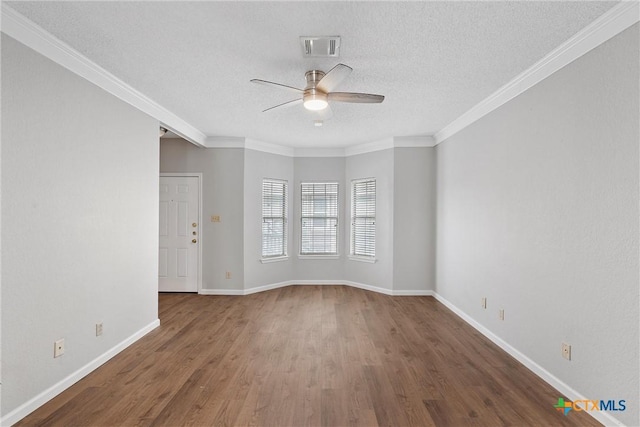 1311 Speight Ave, Waco, TX 76706 - empty room featuring dark hardwood / wood-style flooring, a textured ceiling, crown molding, and ceiling fan