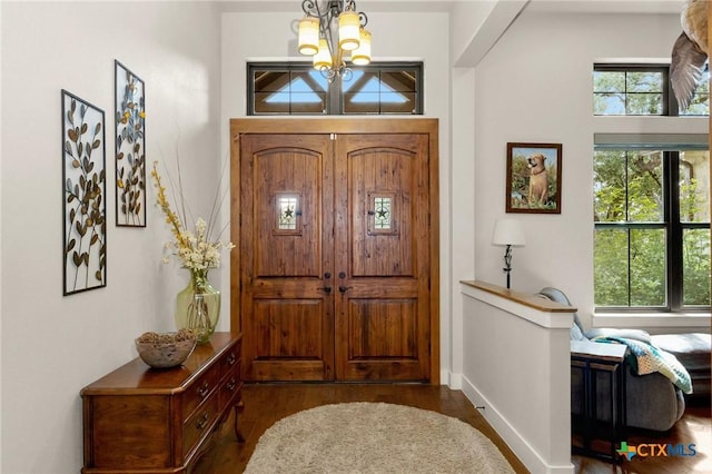 1204 Salt Lick Dr, New Braunfels, TX 78132 - foyer with a chandelier and dark wood finished floors