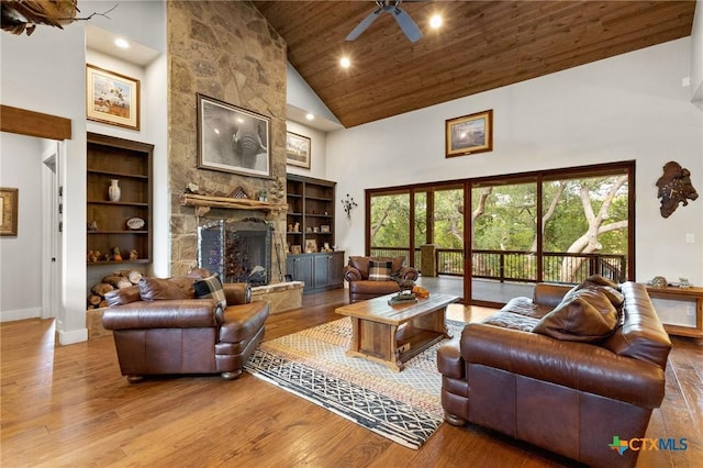 1204 Salt Lick Dr, New Braunfels, TX 78132 - living area featuring high vaulted ceiling, a stone fireplace, wooden ceiling, recessed lighting, and wood finished floors
