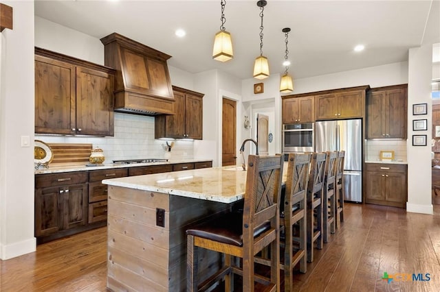 1204 Salt Lick Dr, New Braunfels, TX 78132 - kitchen with stainless steel appliances, dark wood-type flooring, decorative backsplash, a breakfast bar, and recessed lighting