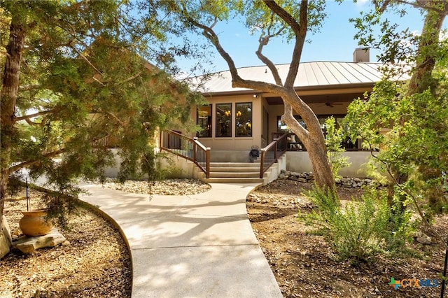 1204 Salt Lick Dr, New Braunfels, TX 78132 - view of front of property with a standing seam roof, a chimney, a metal roof, and a ceiling fan