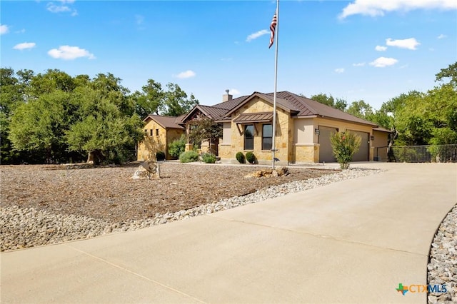 1204 Salt Lick Dr, New Braunfels, TX 78132 - single story home featuring a chimney, a standing seam roof, a garage, stone siding, and a metal roof
