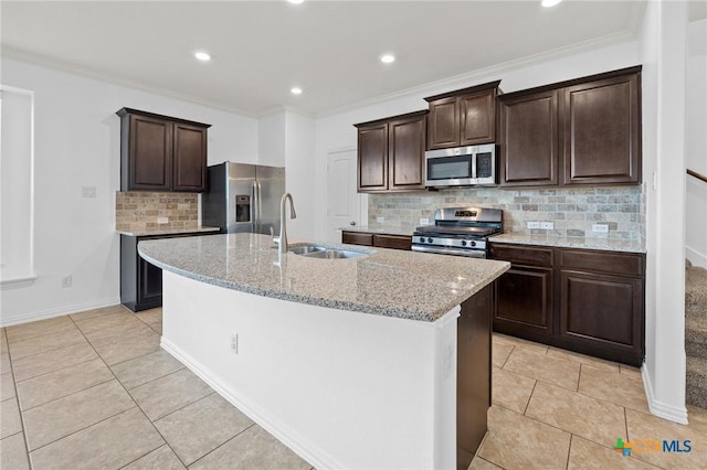 18420 Blush Rose Rd, Pflugerville, TX 78660 - kitchen featuring appliances with stainless steel finishes, a center island with sink, light tile patterned floors, decorative backsplash, and recessed lighting