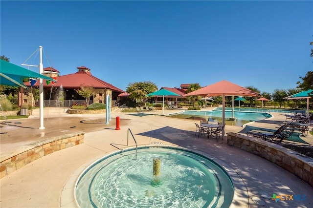 18420 Blush Rose Rd, Pflugerville, TX 78660 - community pool with a community hot tub and a patio area
