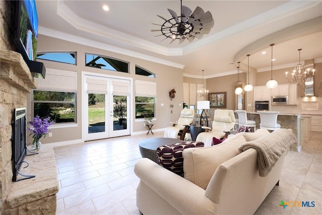 226 Sabella, Spring Branch, TX 78070 - living area featuring a chandelier, a tray ceiling, light tile patterned flooring, ornamental molding, and a fireplace