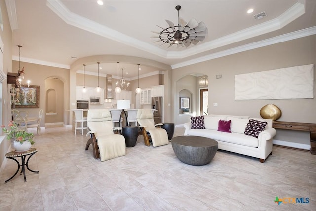 226 Sabella, Spring Branch, TX 78070 - living room with arched walkways, ornamental molding, a tray ceiling, recessed lighting, and a chandelier