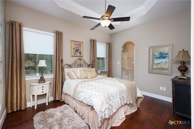 226 Sabella, Spring Branch, TX 78070 - bedroom featuring a raised ceiling, wood finished floors, baseboards, arched walkways, and ensuite bath