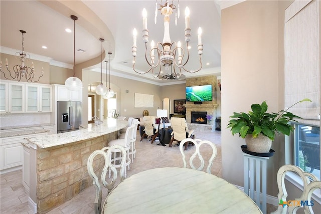226 Sabella, Spring Branch, TX 78070 - dining area featuring a chandelier, crown molding, a lit fireplace, and recessed lighting