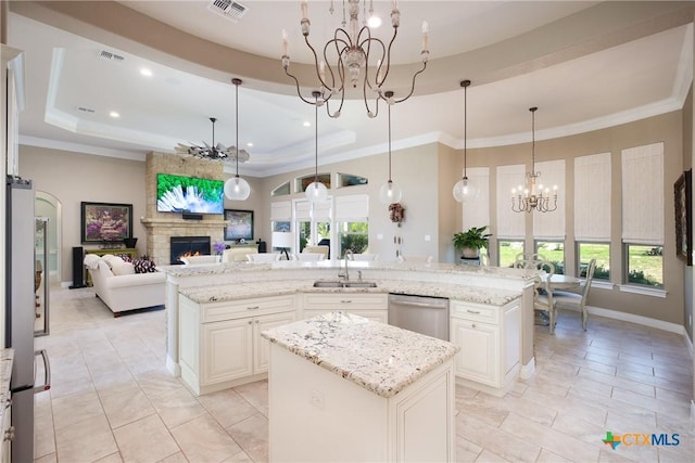 226 Sabella, Spring Branch, TX 78070 - kitchen with a chandelier, a kitchen island with sink, a sink, a raised ceiling, and plenty of natural light