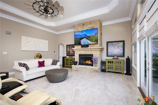 226 Sabella, Spring Branch, TX 78070 - living room featuring a raised ceiling, crown molding, a fireplace, arched walkways, and baseboards