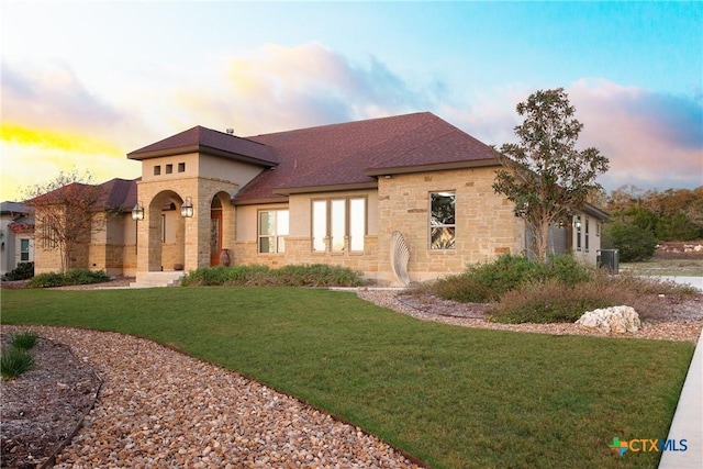 226 Sabella, Spring Branch, TX 78070 - view of front of property featuring stone siding, a yard, a shingled roof, and central air condition unit