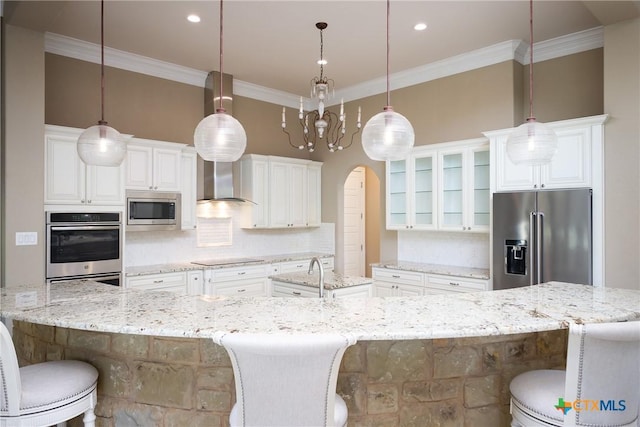 226 Sabella, Spring Branch, TX 78070 - kitchen featuring stainless steel appliances, a large island, wall chimney range hood, crown molding, and backsplash