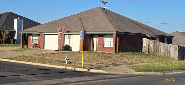 view of front of property featuring a garage and a front lawn