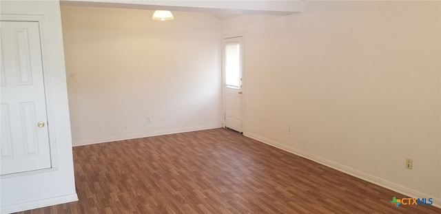 empty room featuring dark wood-type flooring