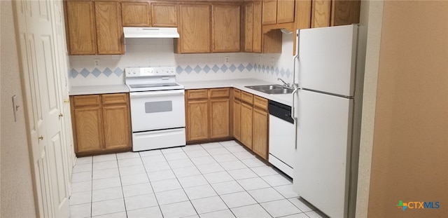 kitchen featuring tasteful backsplash, white appliances, and sink