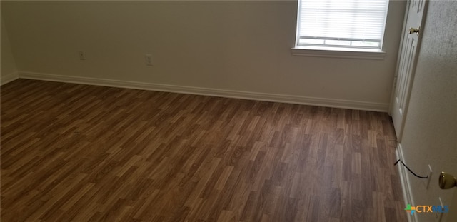 3801 Hitchrock Dr, Killeen, TX 76549 - spare room featuring baseboards and dark wood-style flooring