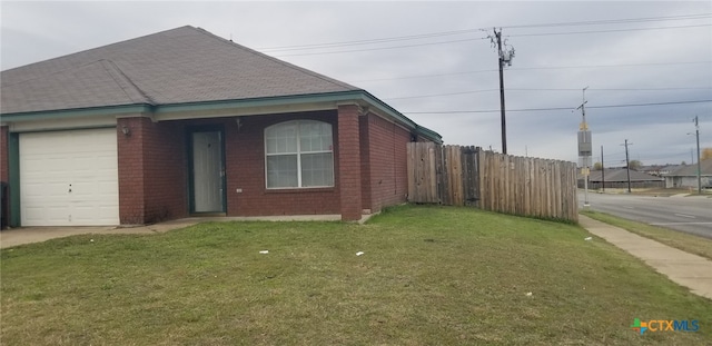 view of side of home featuring a lawn and a garage