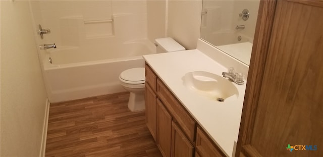 full bathroom with hardwood / wood-style floors, vanity, toilet, and tub / shower combination