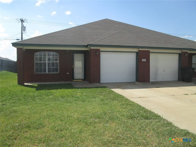 ranch-style house featuring a garage and a front lawn