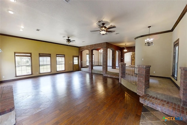 1260 Great Oaks Dr, Salado, TX 76571 - unfurnished living room with arched walkways, ornamental molding, ceiling fan, wood finished floors, and recessed lighting