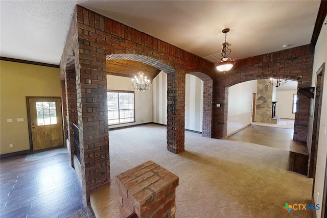 1260 Great Oaks Dr, Salado, TX 76571 - unfurnished living room with arched walkways, plenty of natural light, a chandelier, and carpet flooring