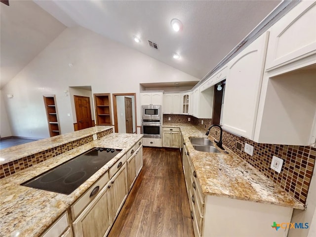 1260 Great Oaks Dr, Salado, TX 76571 - kitchen featuring appliances with stainless steel finishes, dark wood finished floors, glass insert cabinets, light stone counters, and tasteful backsplash