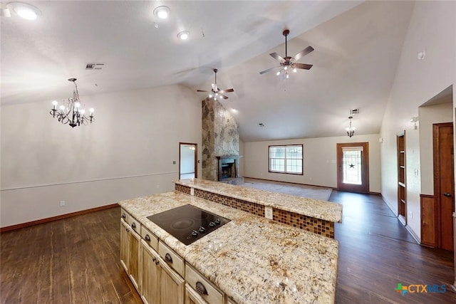 1260 Great Oaks Dr, Salado, TX 76571 - kitchen with black electric cooktop, dark wood-style floors, open floor plan, a large fireplace, and a center island