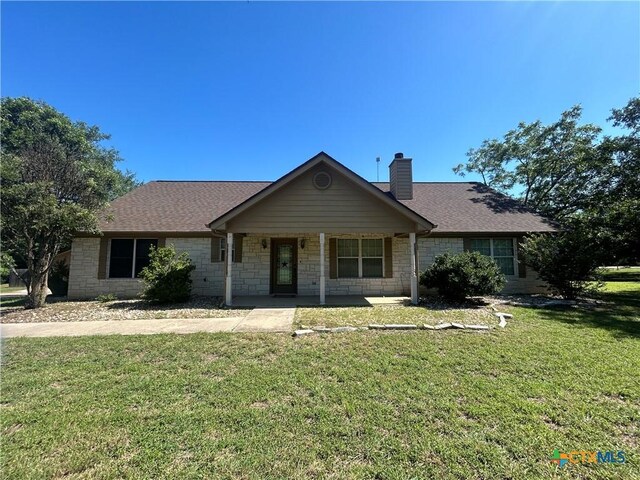 1260 Great Oaks Dr, Salado, TX 76571 - ranch-style house featuring stone siding, a front lawn, a chimney, and covered porch