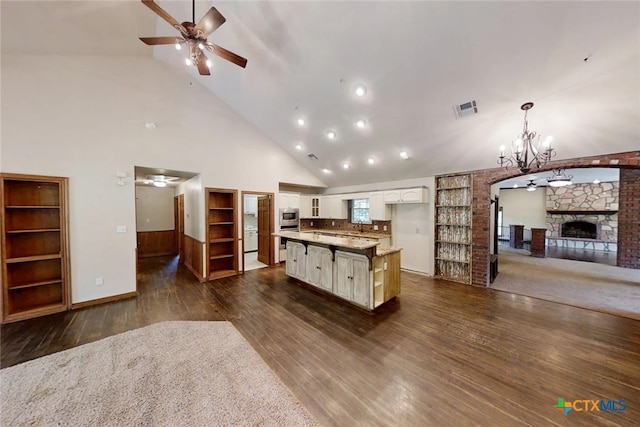 1260 Great Oaks Dr, Salado, TX 76571 - kitchen featuring ceiling fan, dark wood finished floors, open floor plan, high vaulted ceiling, and white cabinetry