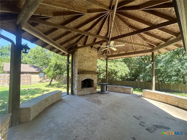1260 Great Oaks Dr, Salado, TX 76571 - fenced backyard featuring an outdoor stone fireplace, a gazebo, a patio, and a ceiling fan