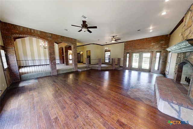 1260 Great Oaks Dr, Salado, TX 76571 - unfurnished living room featuring a ceiling fan, hardwood / wood-style flooring, a fireplace, and brick wall