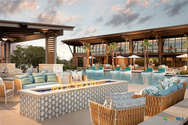 community pool with an outdoor hangout area and a patio