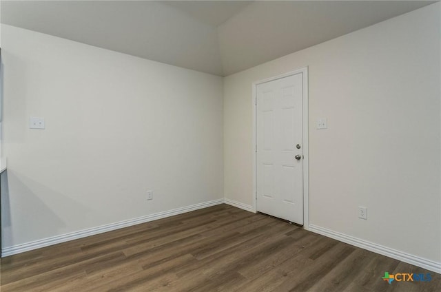 1003 Antelope Trl, Temple, TX 76504 - spare room with baseboards, dark wood-style flooring, and lofted ceiling
